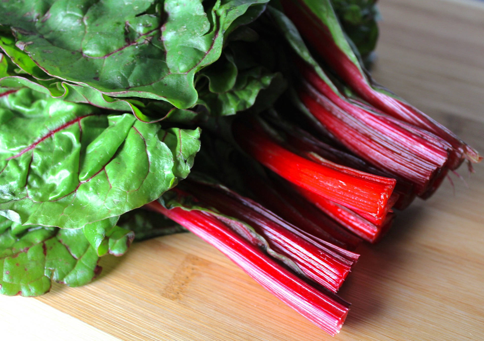 Caption: Fresh Ruby Red Swiss Chard In High Resolution Background