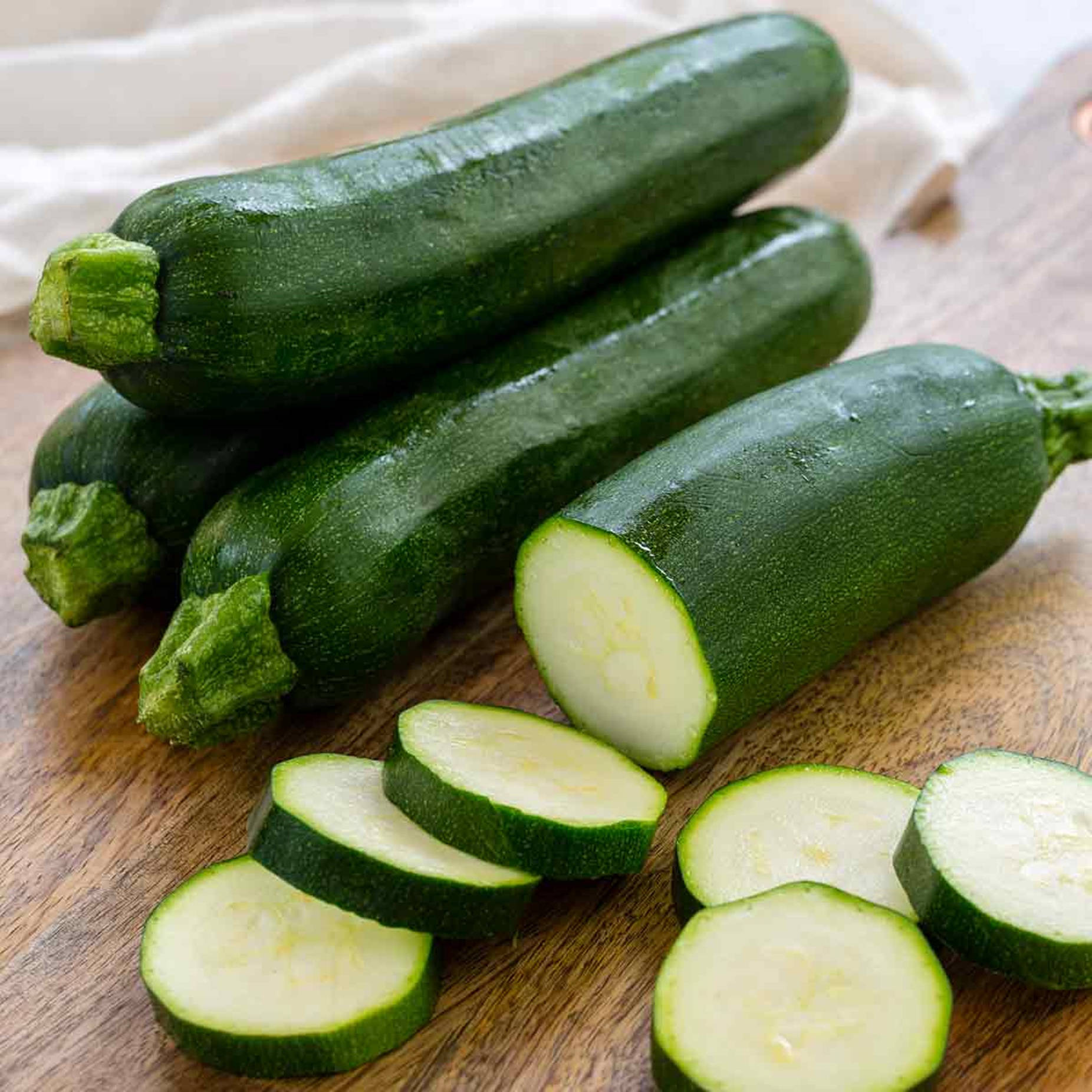 Caption: Fresh Zucchini Slices Showcasing White Flesh Background