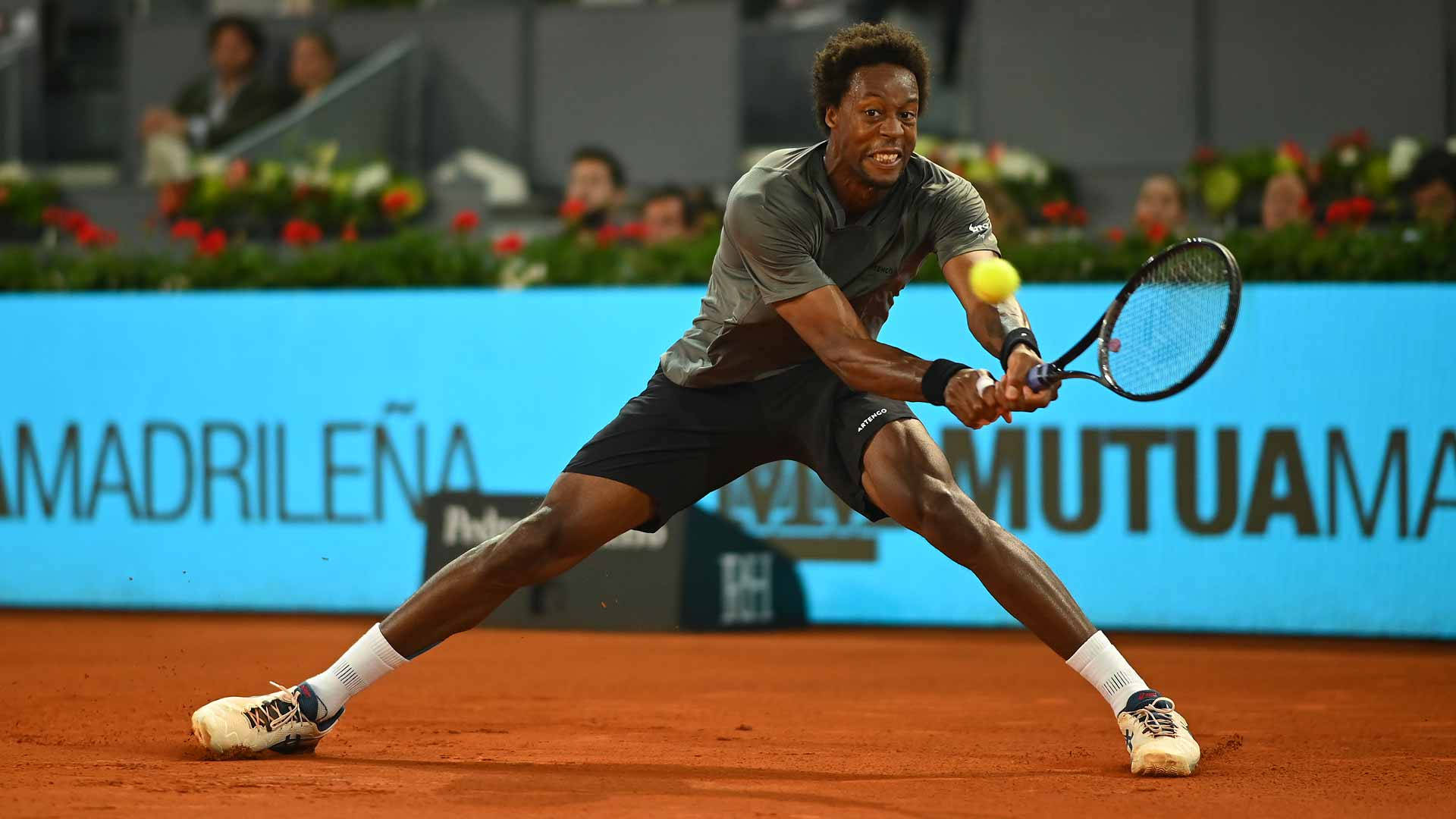 Caption: Gael Monfils In Action On Court Background