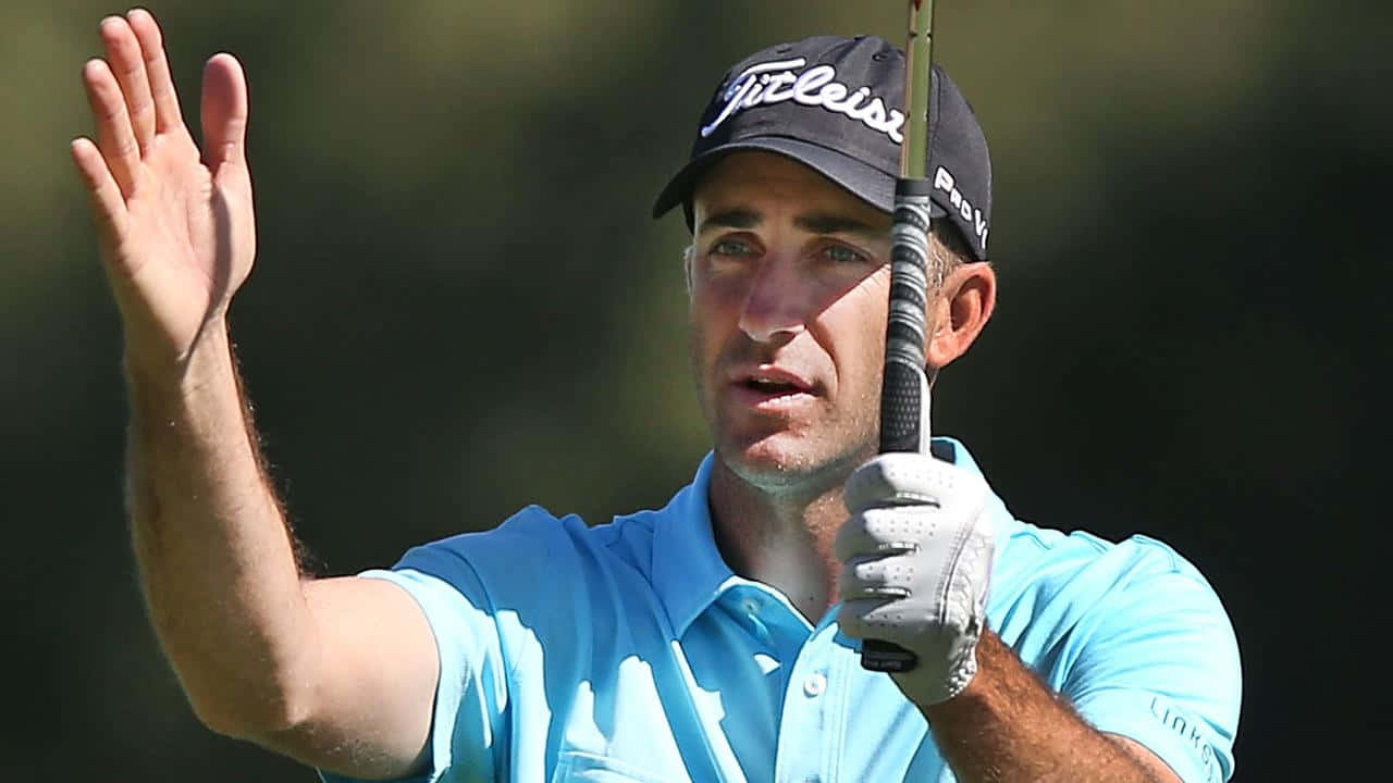 Caption: Geoff Ogilvy In Action On The Golf Course Background