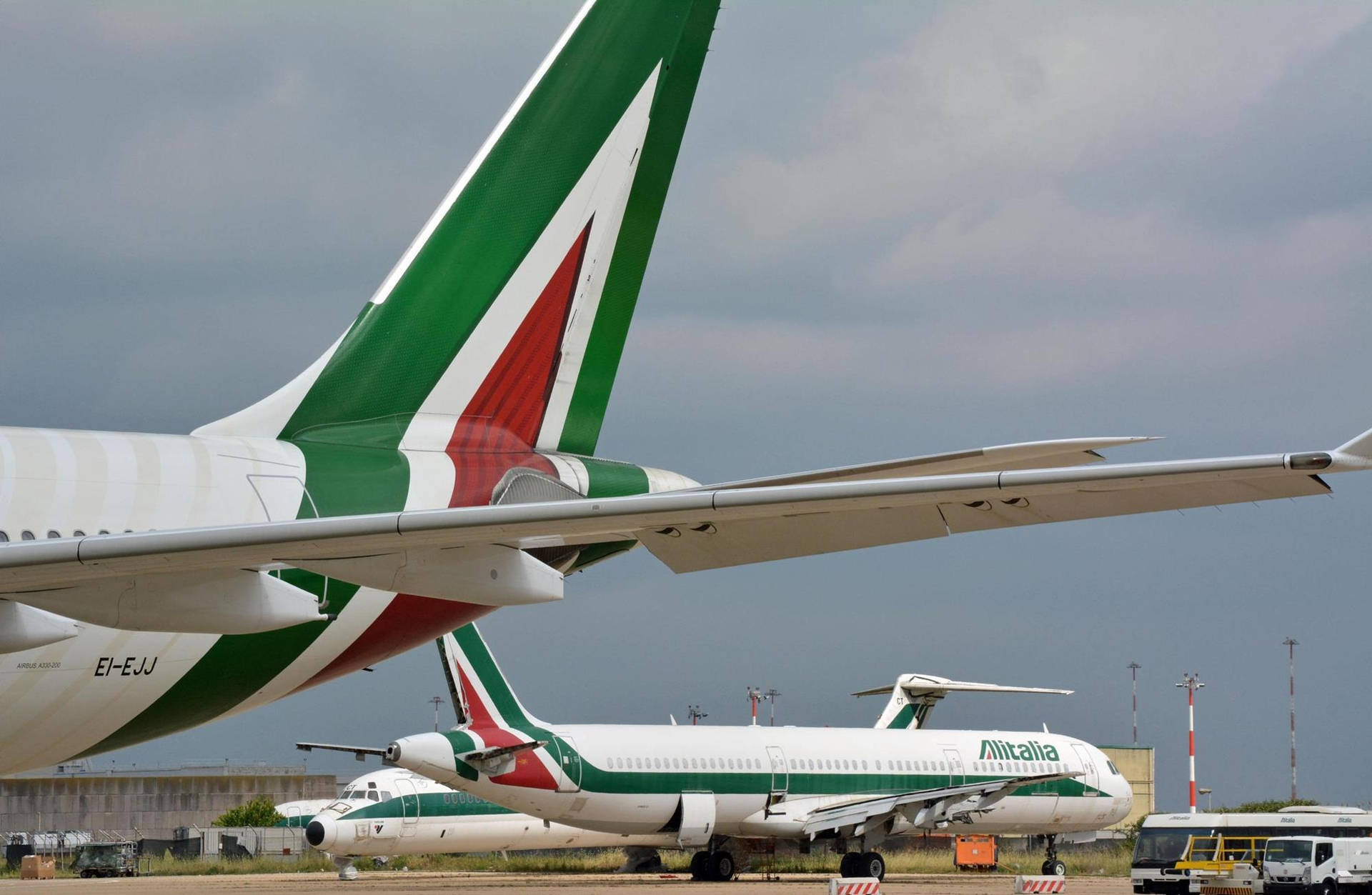 Caption: Glimpse Of Alitalia's Rudder In Flight Background