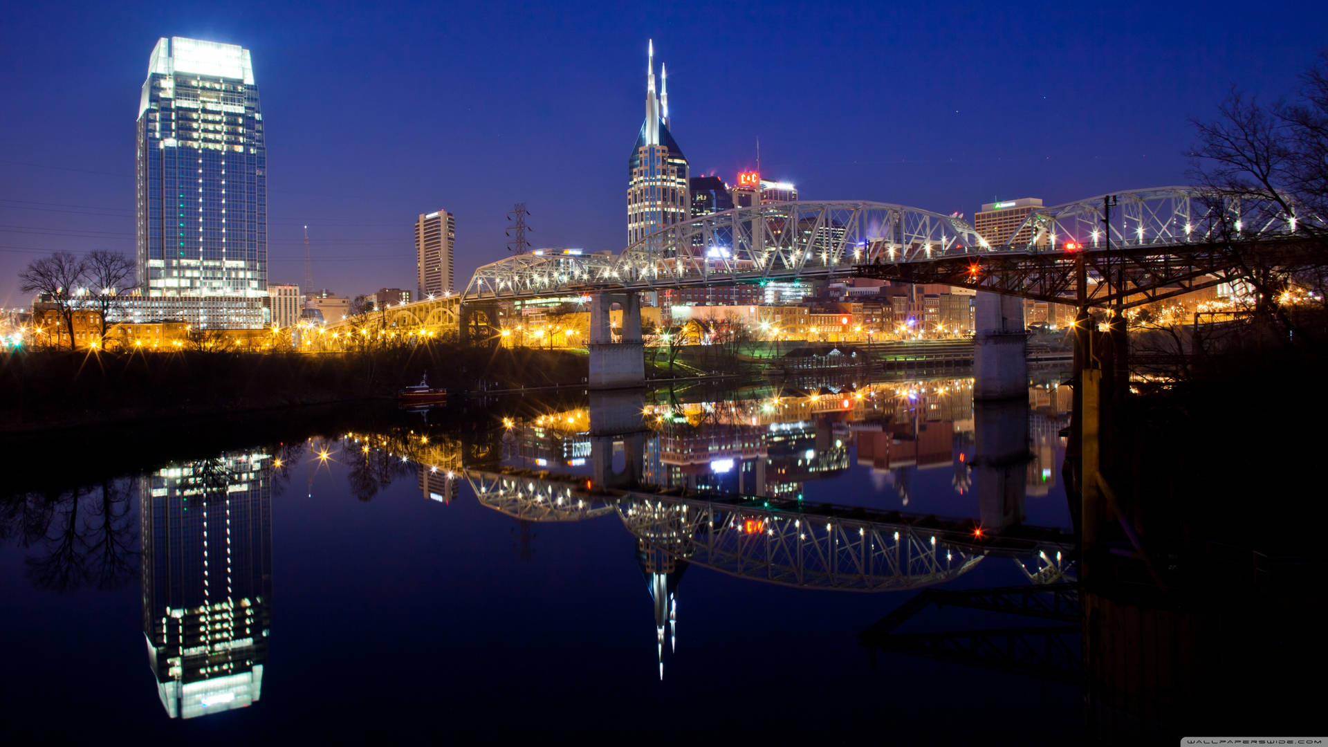 Caption: Glistening Night Skyline Of Jersey City, New Jersey Background