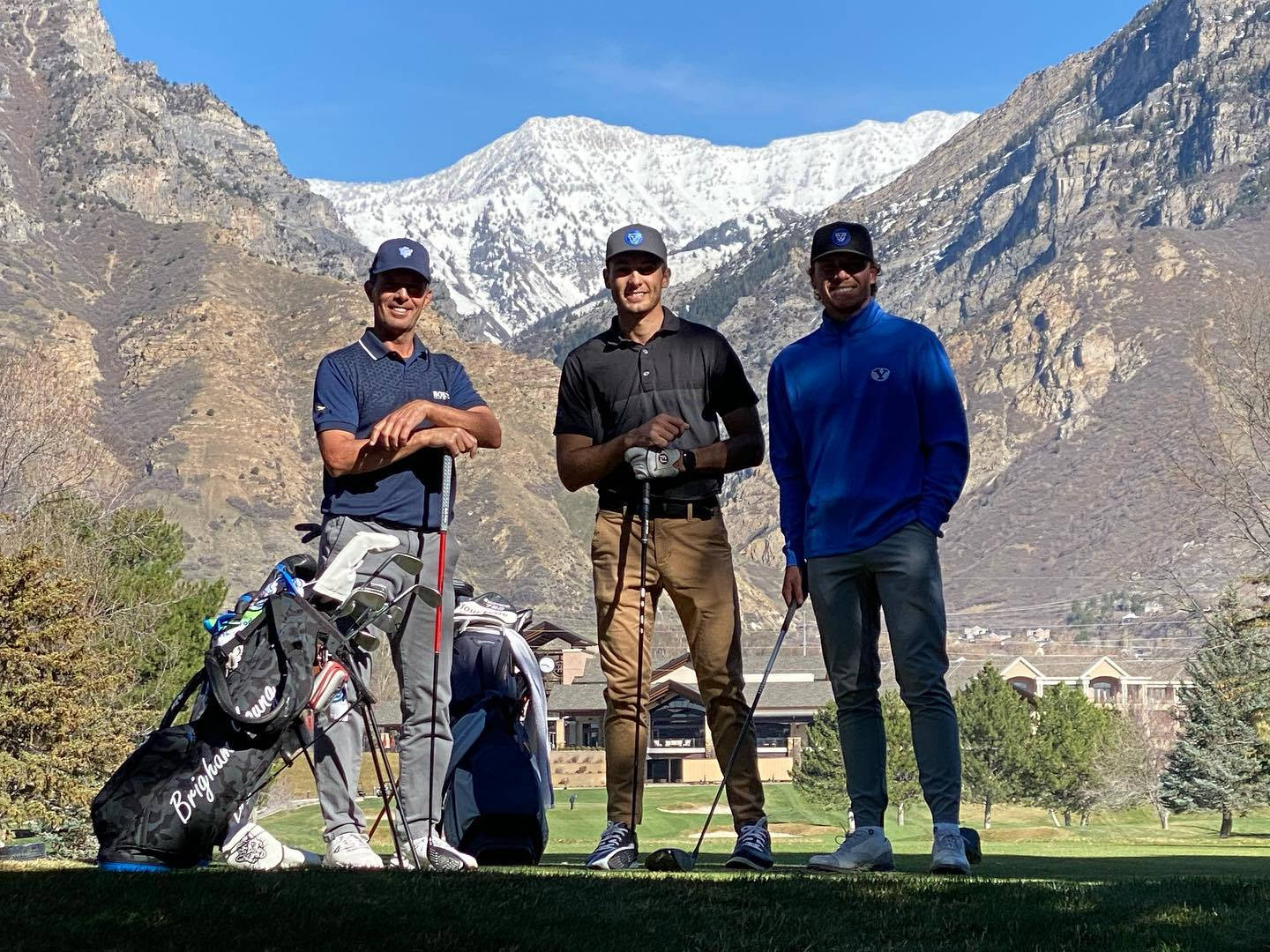 Caption: Golf Professional Mike Weir Standing With Fellow Golfers Background