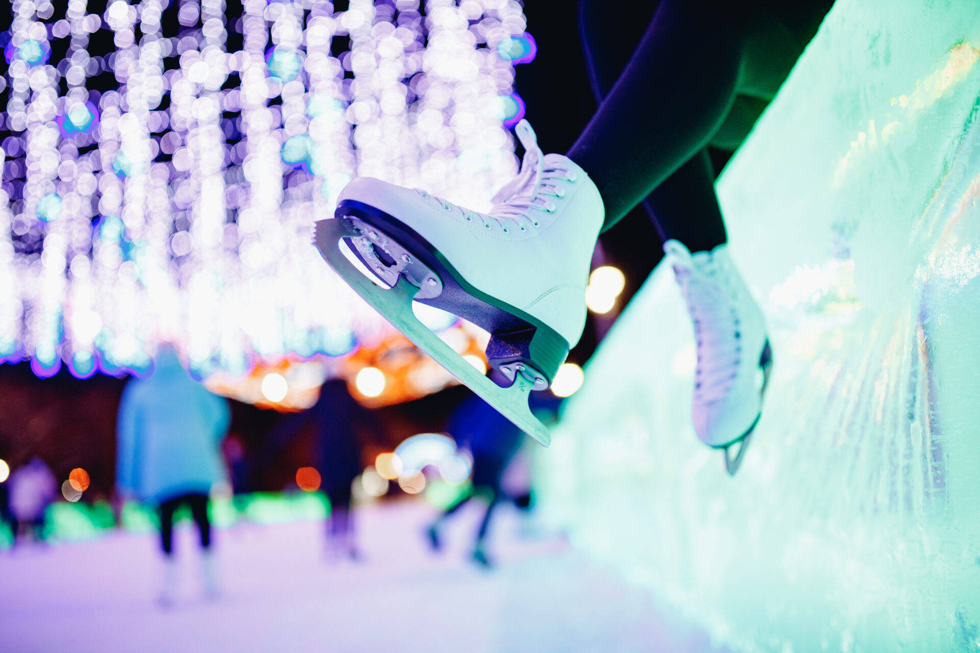 Caption: Grace On Ice: A Pair Of White Ice Skating Shoes Background