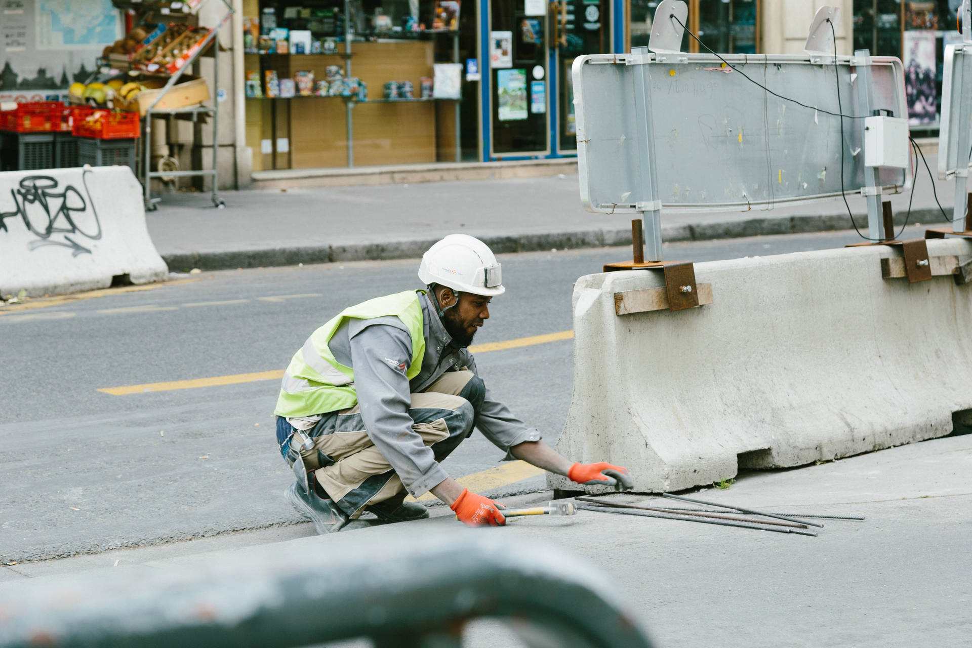 Caption: Hard-working Construction Worker In Action Background