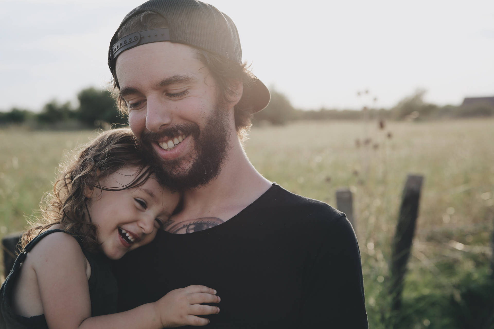 Caption: Heartwarming Moment Between Father And Son Background