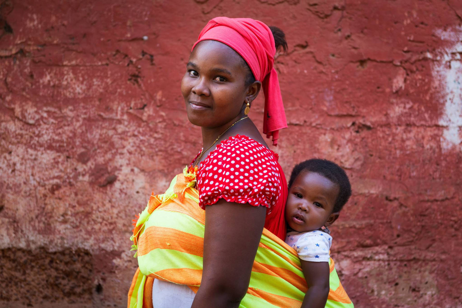 Caption: Heartwarming Scene Of A Mother And Child In Guinea-bissau Background