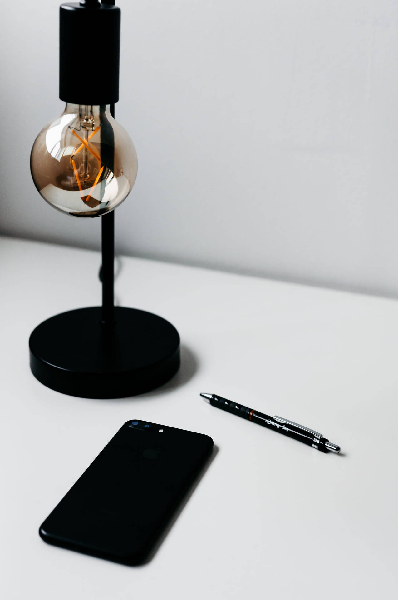 Caption: Illuminated Iphone On A Minimalist Desk