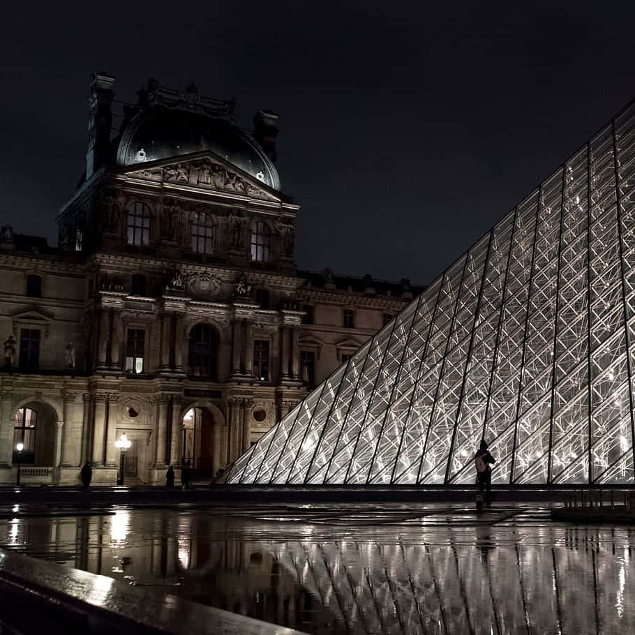 Caption: Illuminated Louvre Museum At Night Background