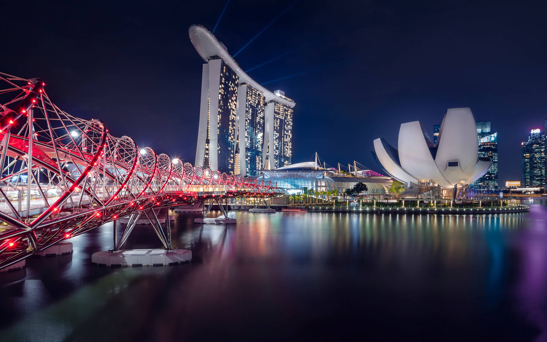 Caption: Illuminated Marina Bay Sands At Night Background