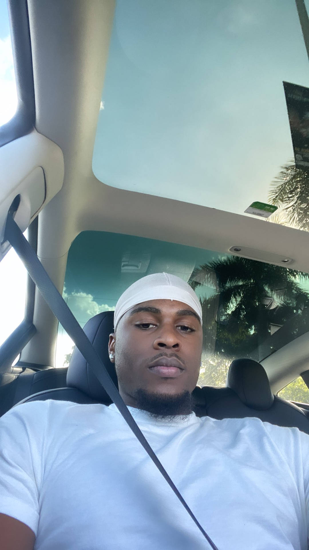 Caption: Instagram Star Swavy Lee Living The White-themed Luxury In A Car Selfie Background