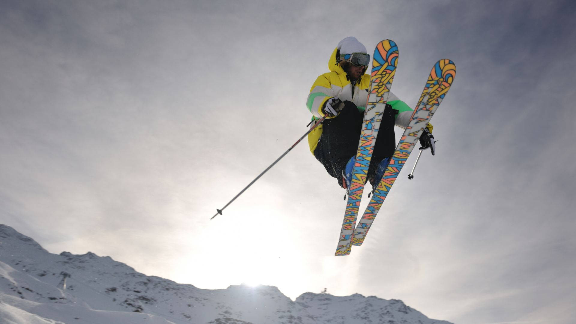 Caption: Intense Action Mid-air - Ski Jumper In Motion Background