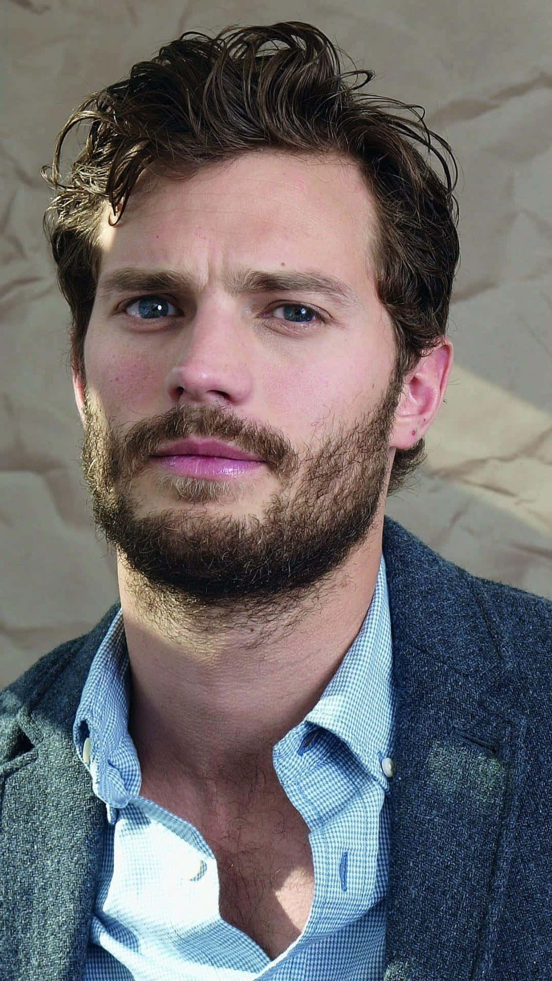 Caption: Jamie Dornan Exuding Casual Elegance Background