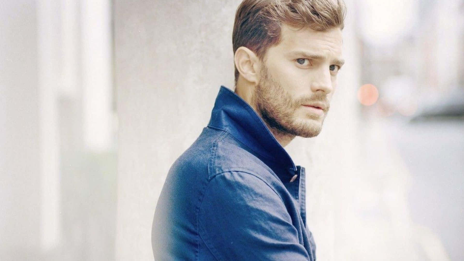 Caption: Jamie Dornan - The Epitome Of Structured Elegance Background