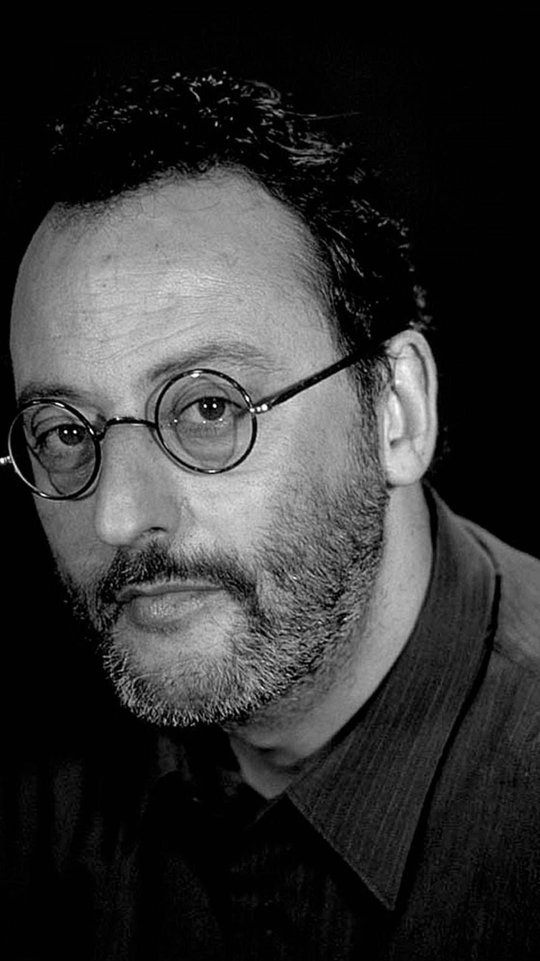 Caption: Jean Reno In Monochrome Background