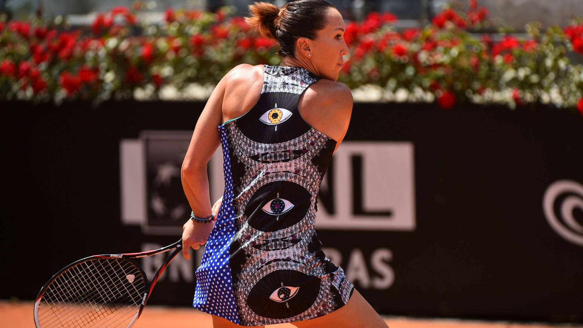 Caption: Jelena Jankovic Sporting An Eye-pattern Dress At A Tennis Event. Background