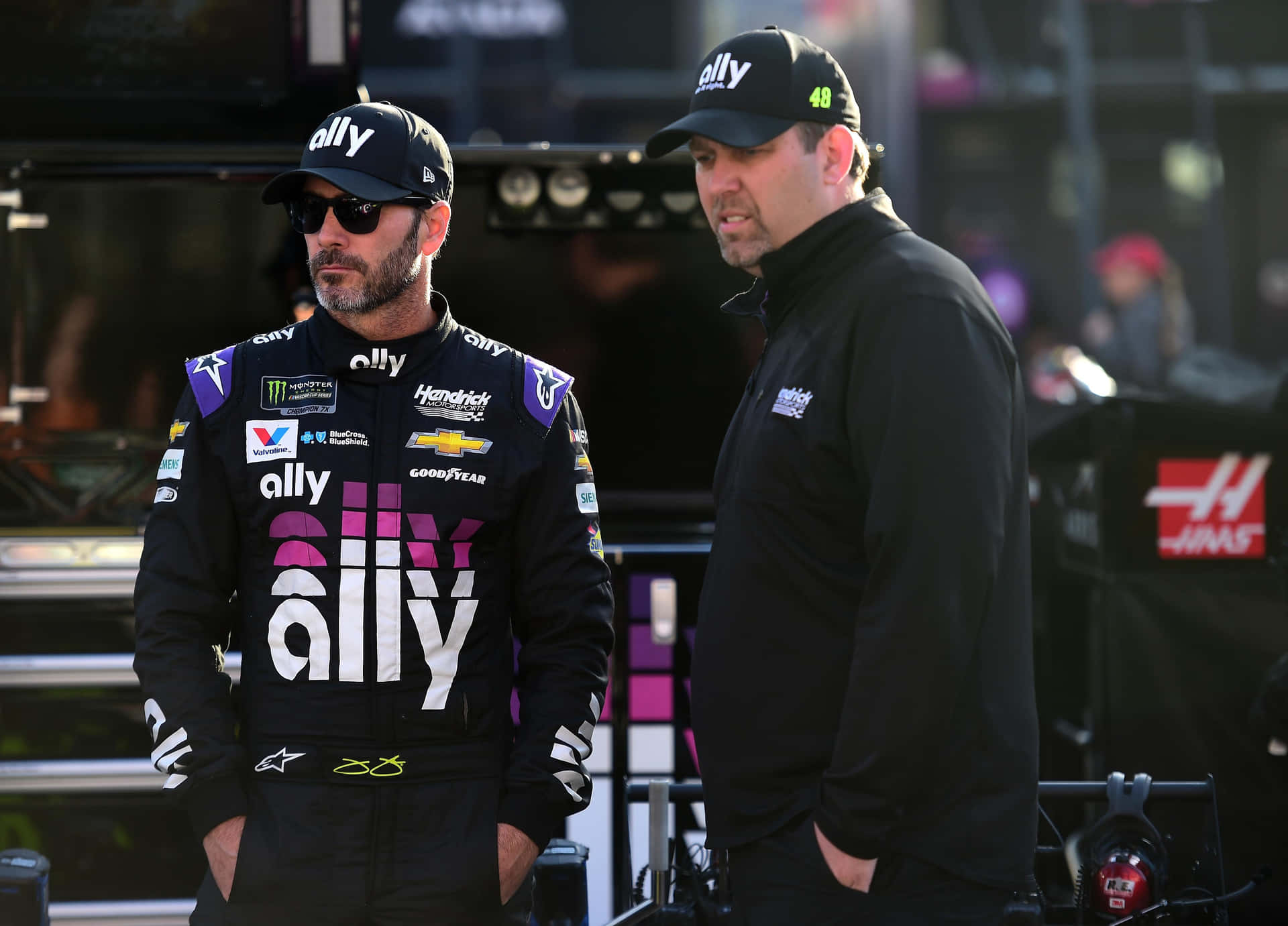 Caption: Jimmie Johnson Racing At Full Speed On The Track Background