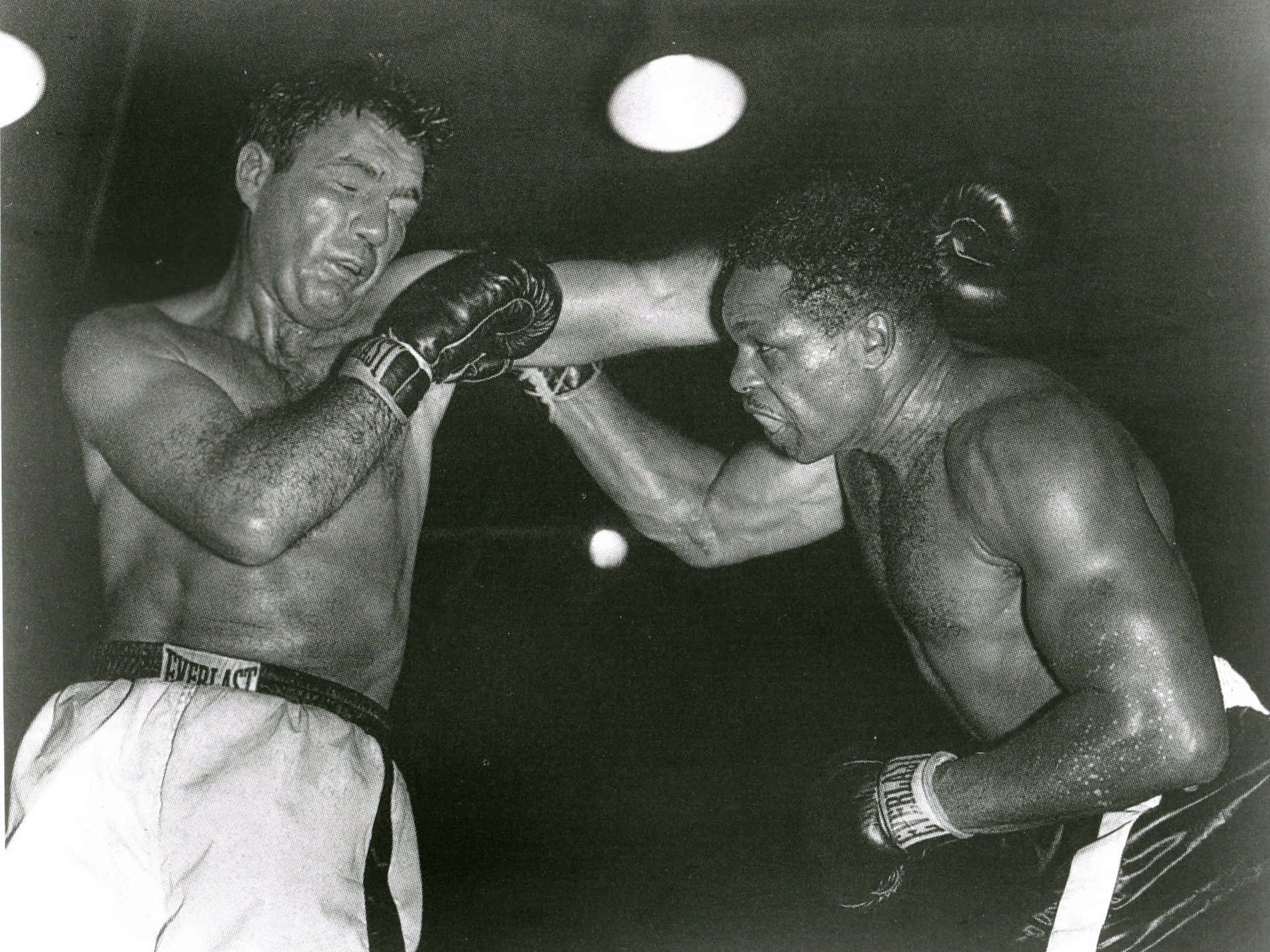 Caption: Joey Maxim Displaying Valor In The Ring Background