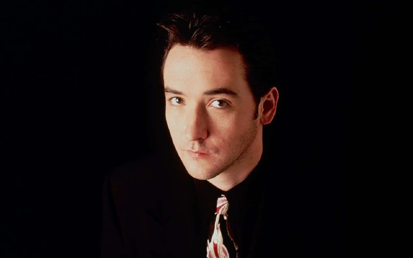 Caption: John Cusack In A Reflective Pose Background