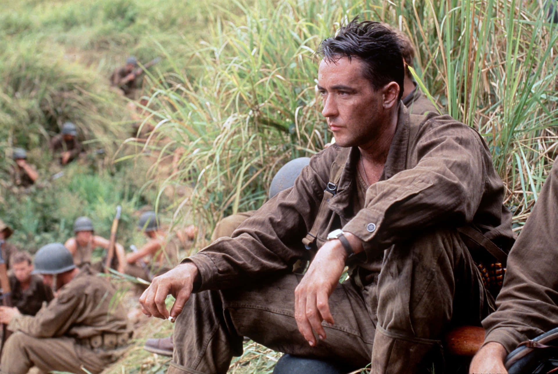 Caption: John Cusack Leaning On A Classic Car Background