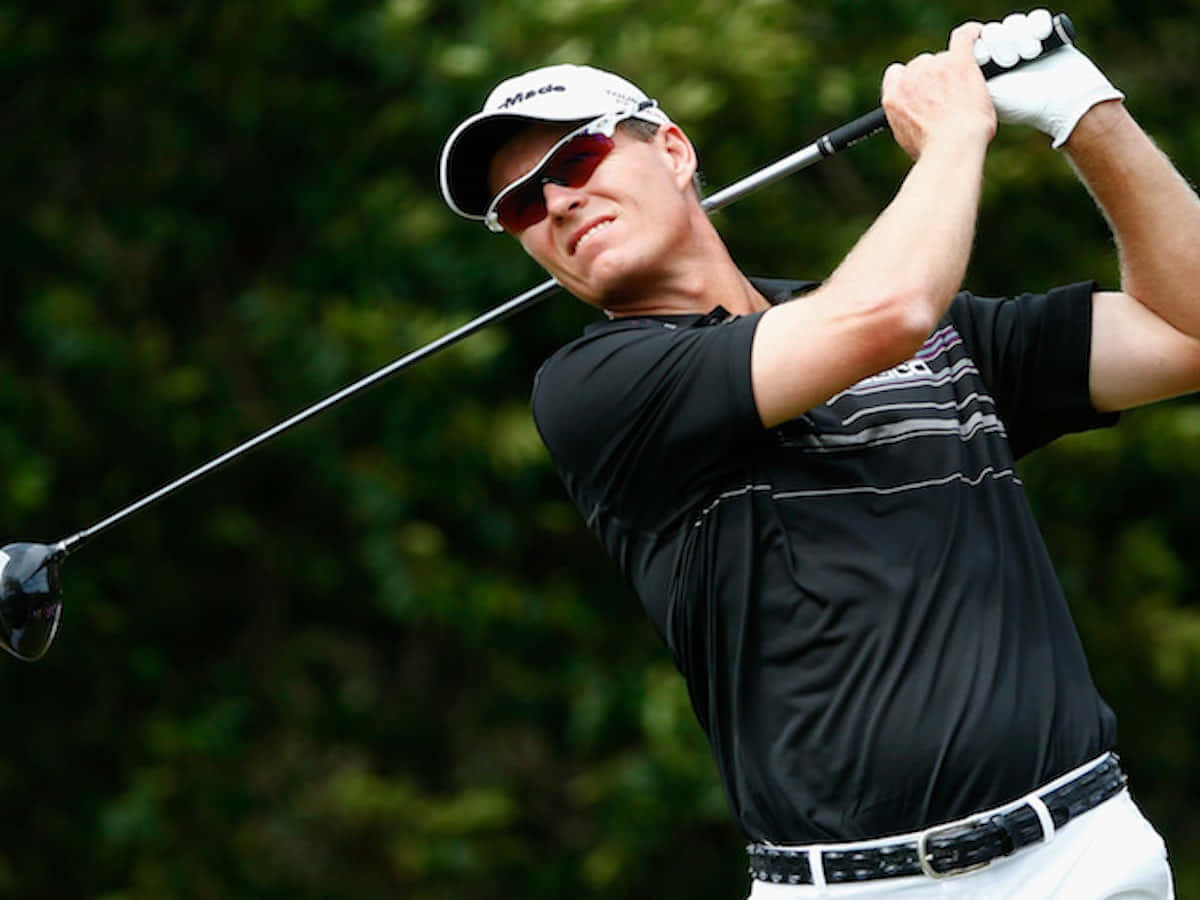 Caption: John Senden Exhibiting Perfect Post-swing Pose At A Golf Event. Background