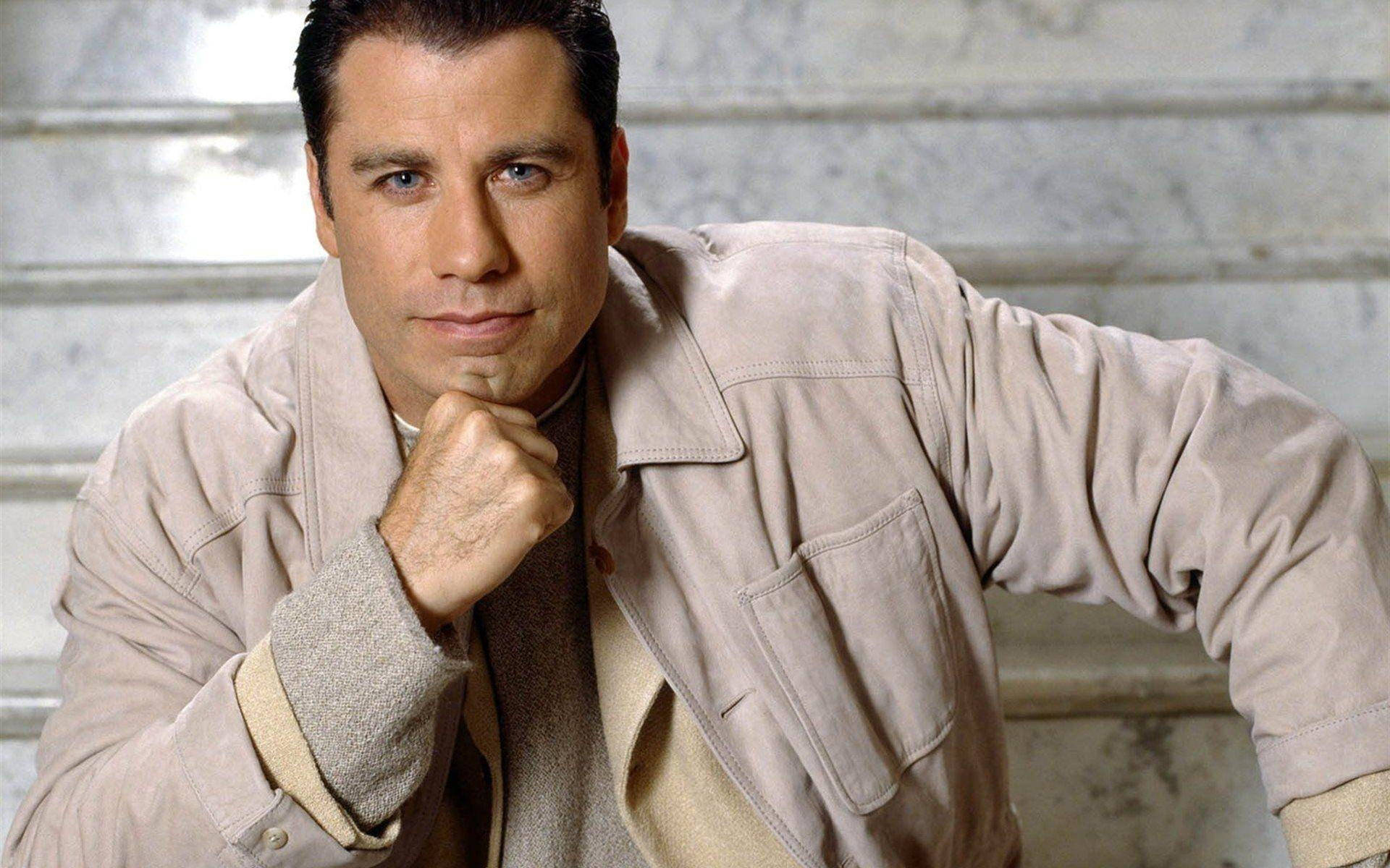 Caption: John Travolta: Iconic American Actor In Creative Pose Background