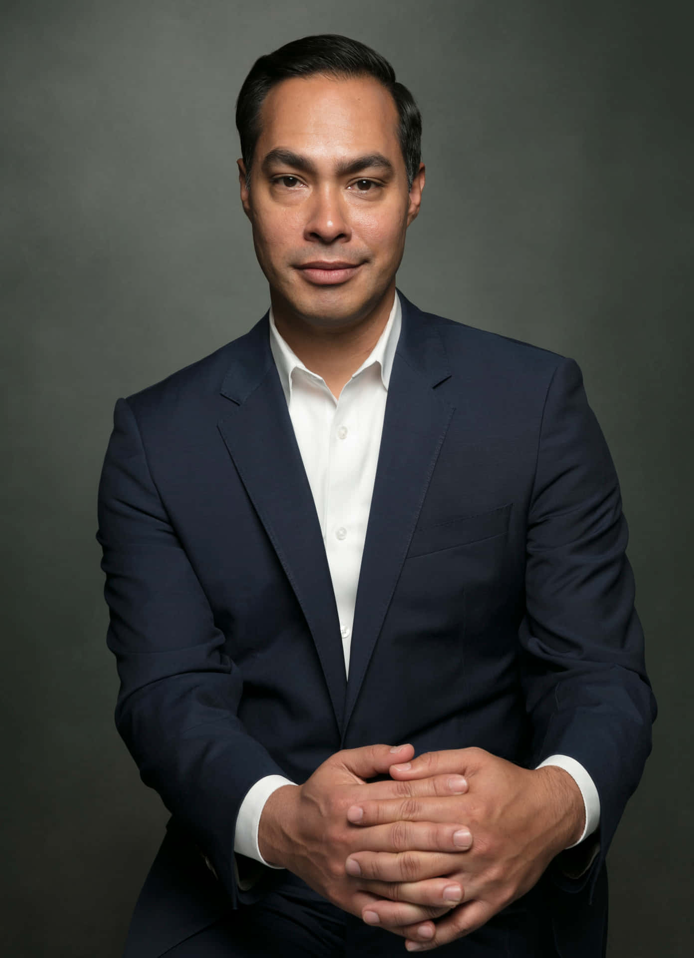 Caption: Julian Castro Posing With A Gray Background Background