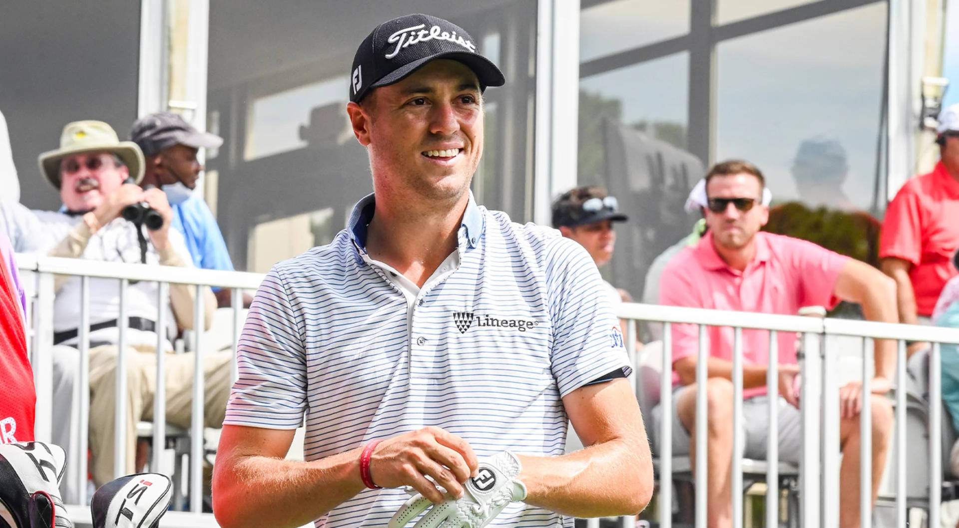 Caption: Justin Thomas Wearing A Striped Polo During Golf Tournament Background