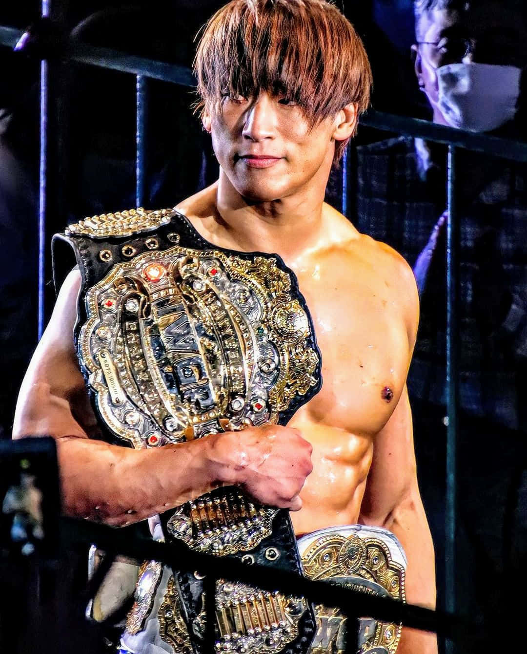 Caption: Kota Ibushi Holding Iwgp Intercontinental Champion Title