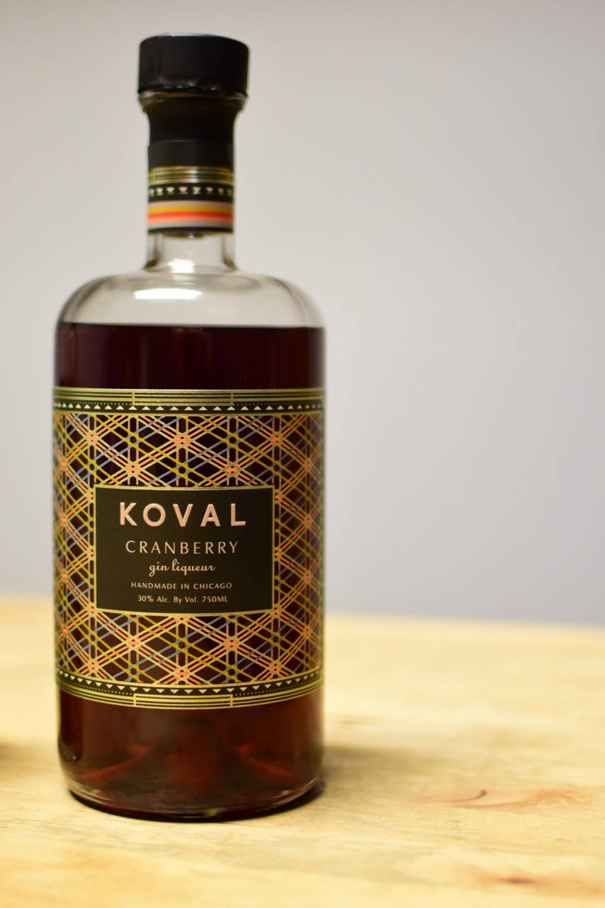 Caption: Koval Artisan Crafted Cranberry Gin Liqueur Background