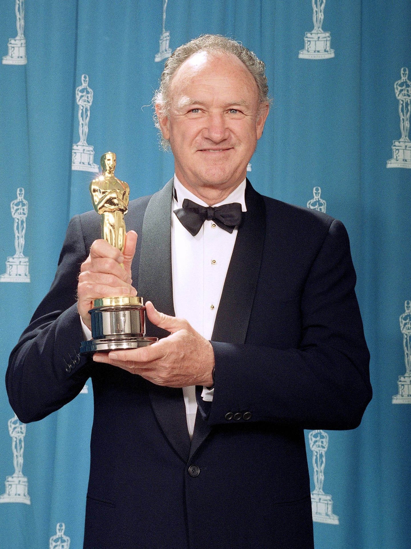 Caption: Legendary Actor Gene Hackman Celebrating With His Oscars Background