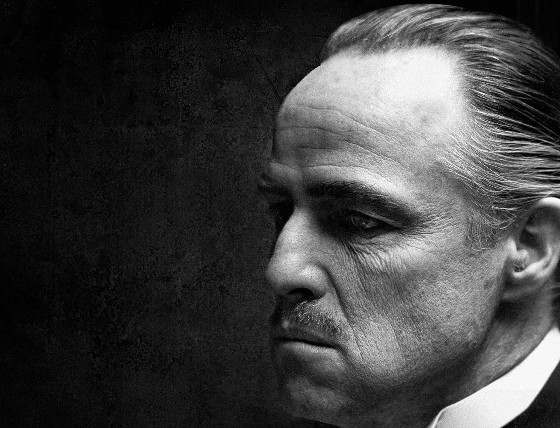 Caption: Legendary Actor Marlon Brando In The Godfather Trilogy Background