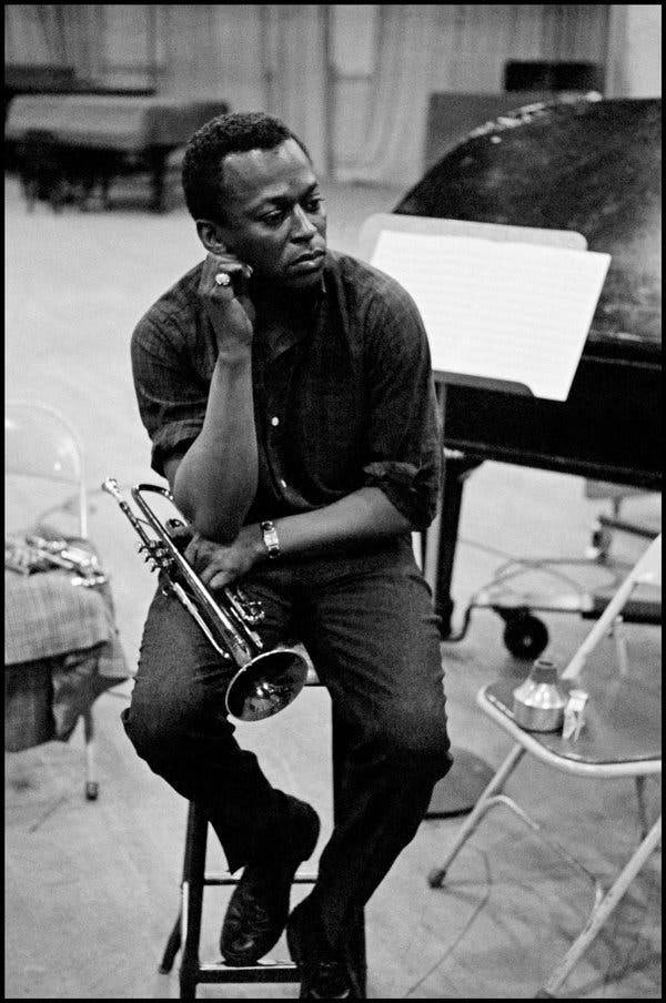 Caption: Legendary Jazz Musician - Miles Davis Background