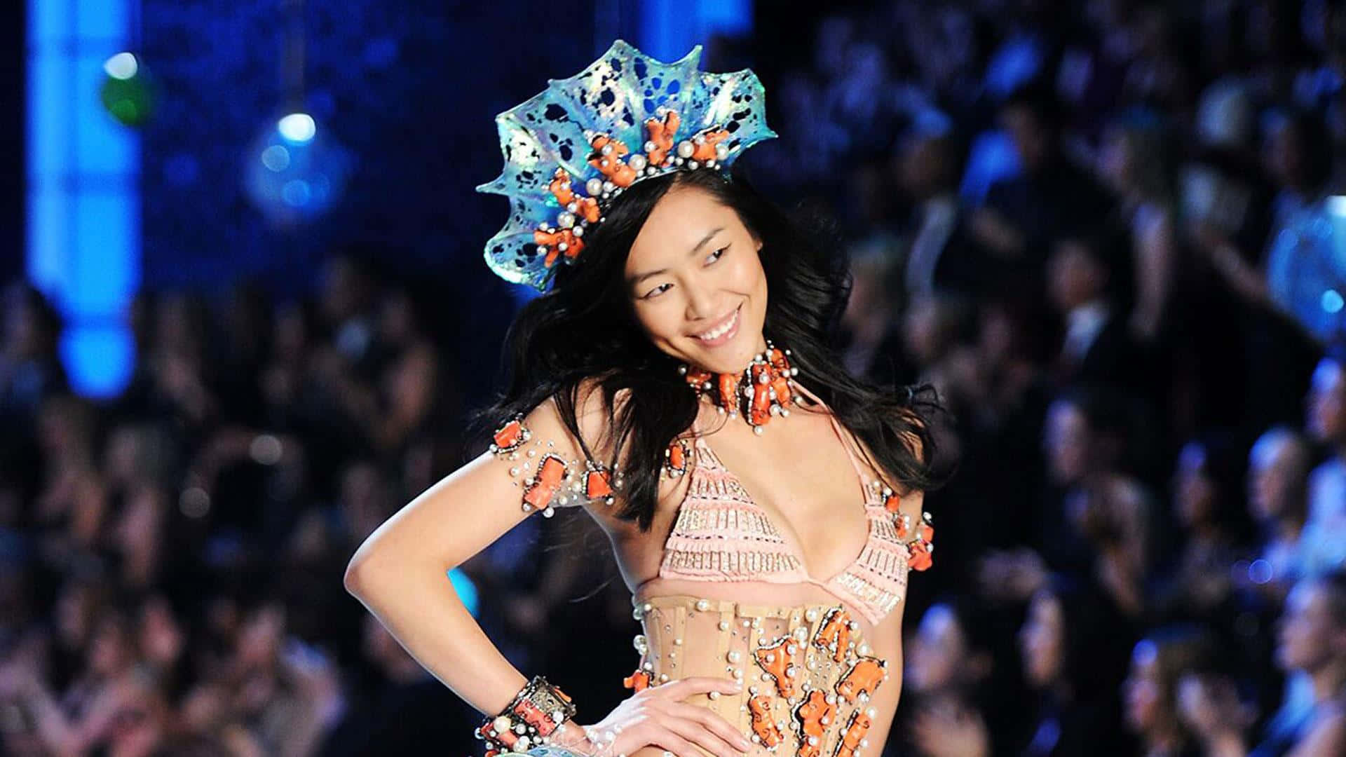 Caption: Liu Wen Showing Her Confident Style On A Catwalk Background