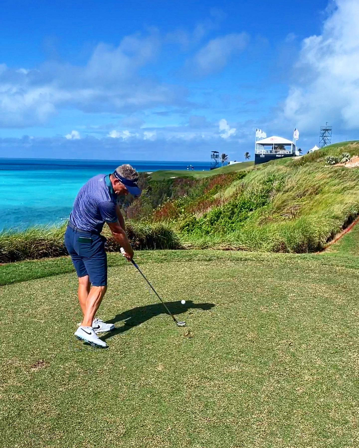 Caption: Luke Donald Contemplating His Next Stroke Against A Stunning Seaside View Background