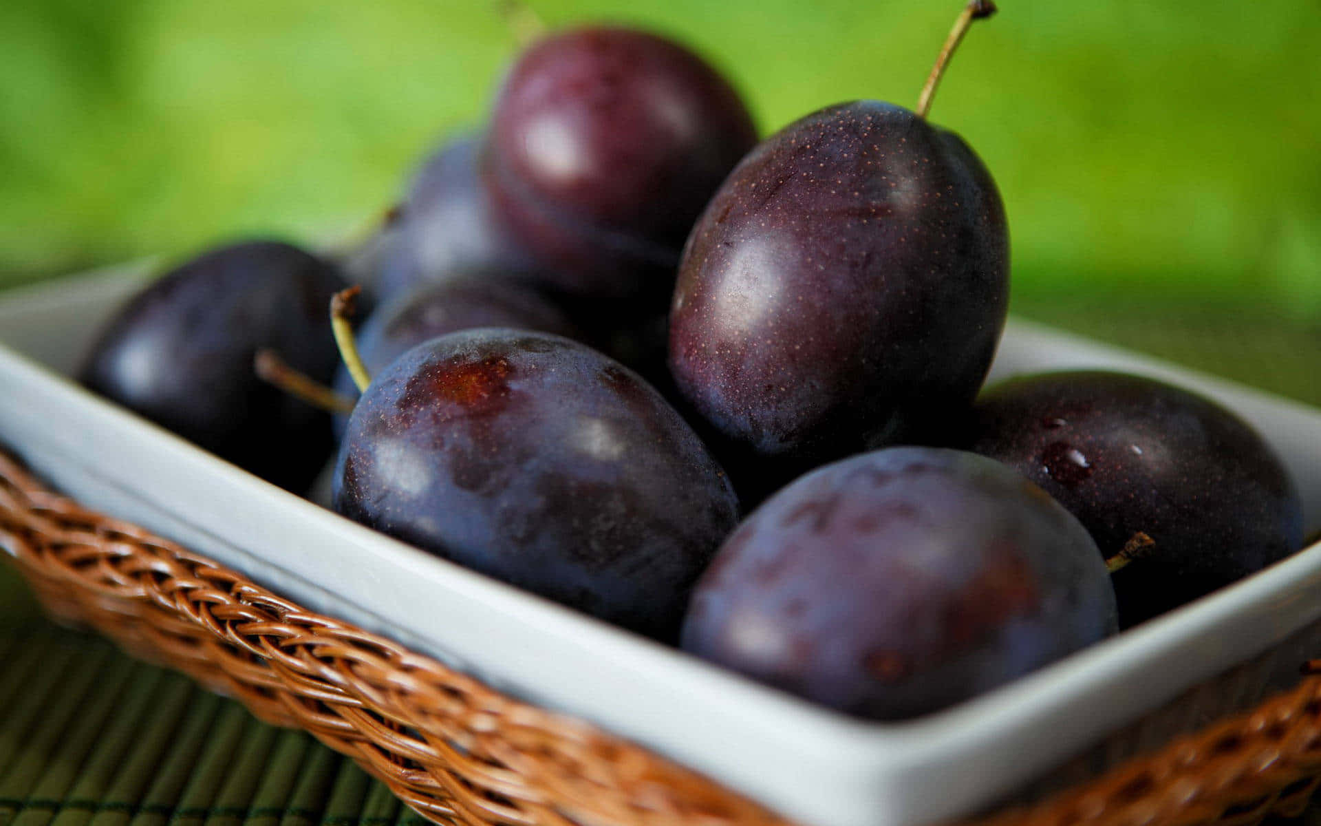 Caption: Luscious Italian Prune Plums Displayed On A Fruit Platter Background