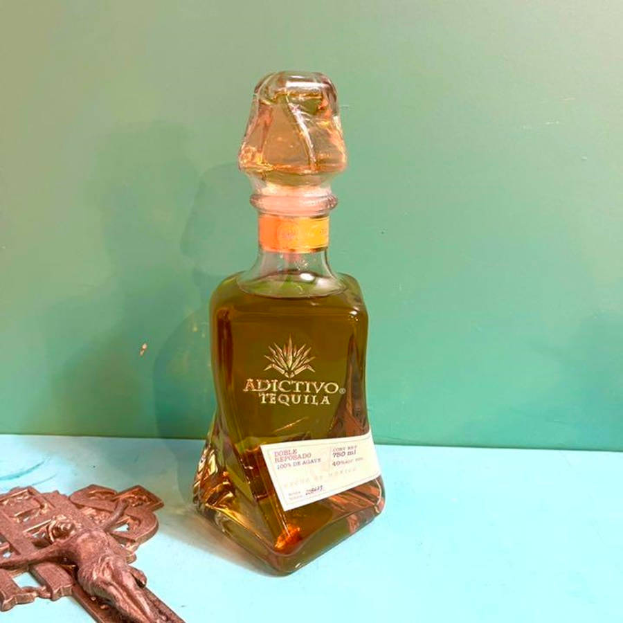 Caption: Luxurious Adictivo Extra Anejo Tequila Bottle Background