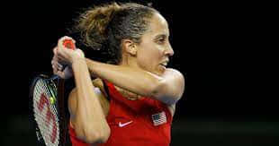 Caption: Madison Keys In Action During A Professional Tennis Tournament. Background