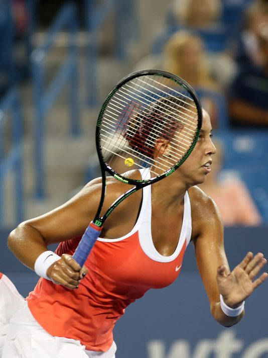 Caption: Madison Keys In Action On The Tennis Court Background