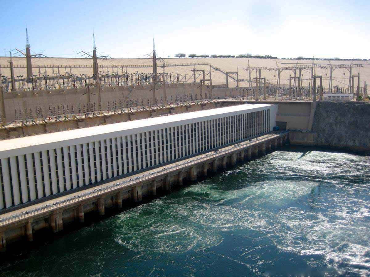 Caption: Majestic Aswan High Dam – Powering Egypt Background