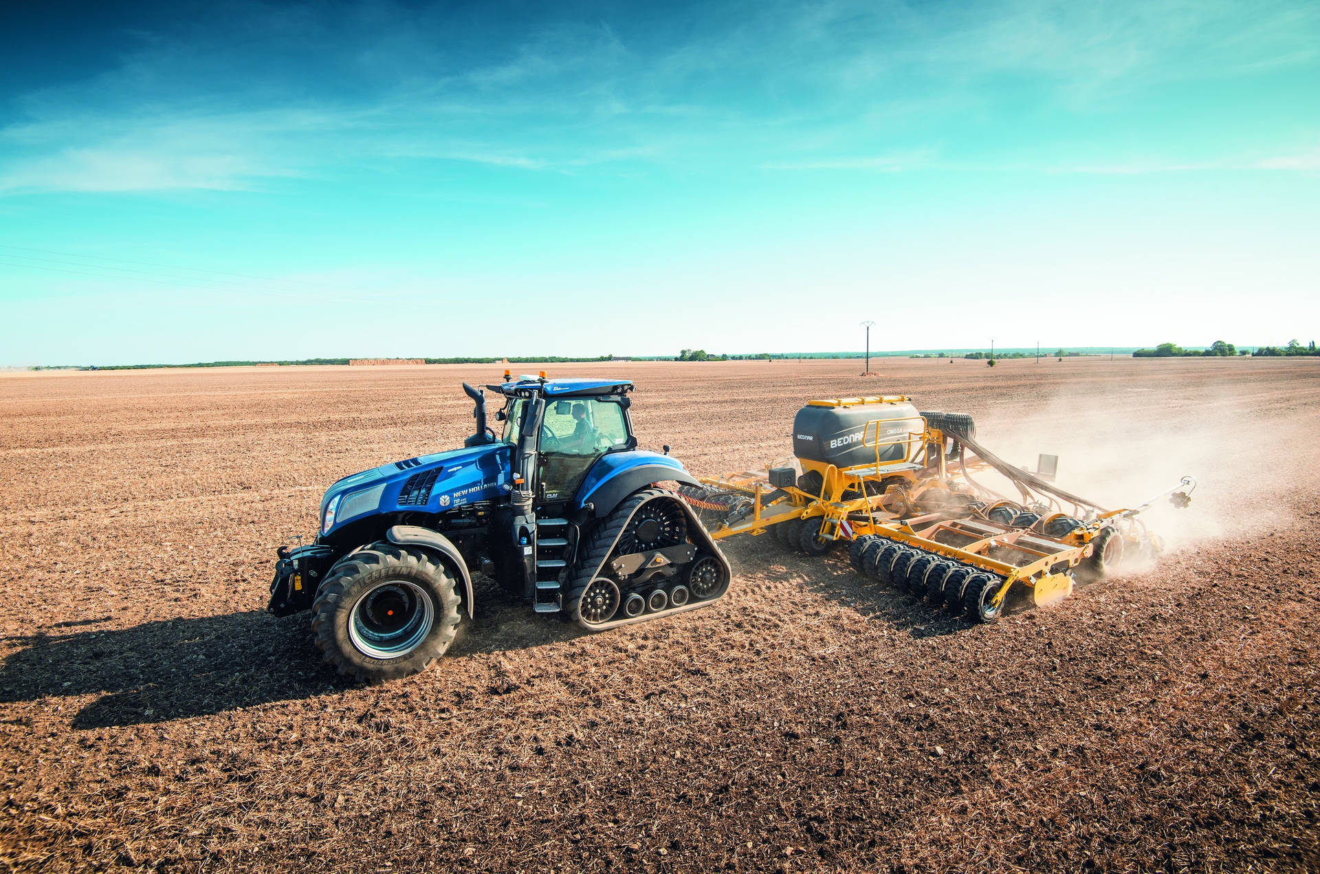 Caption: Majestic Blue New Holland Tractor In The Countryside Background