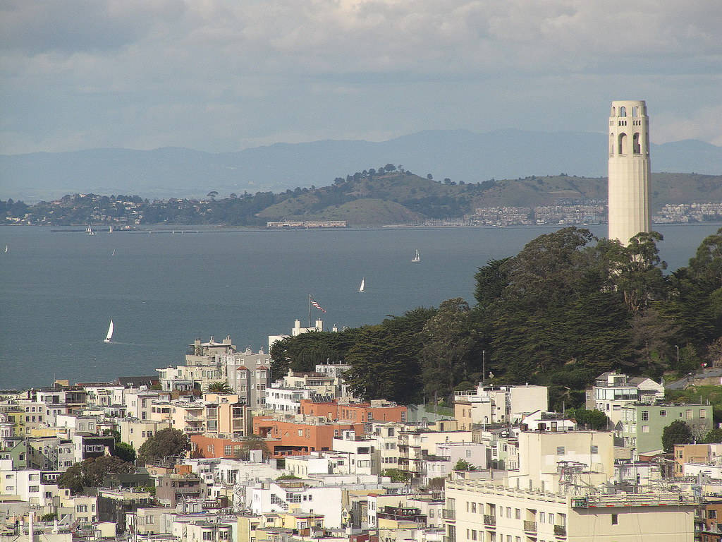 Caption: Majestic Coit Tower Overlooking The Bustling San Francisco Bay Background