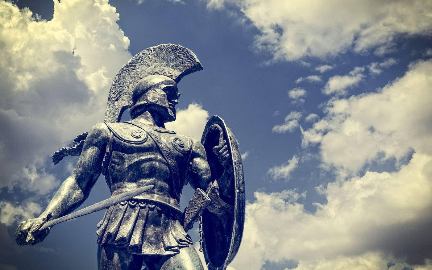 Caption: Majestic Greek Warrior Statue Background