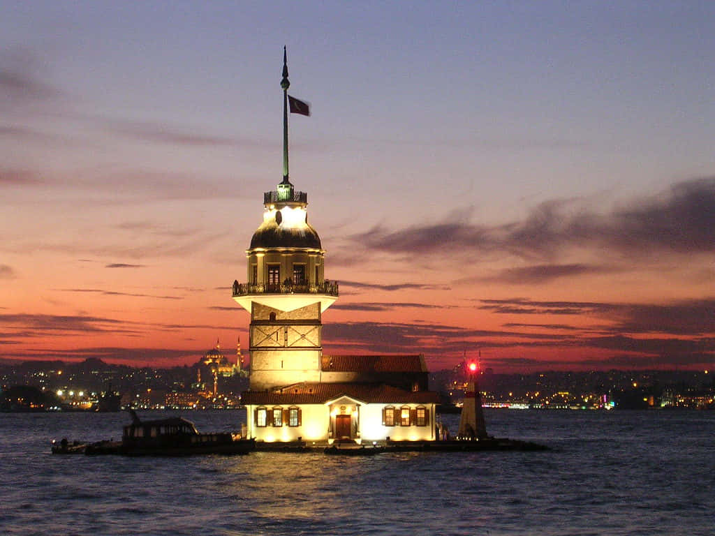 Caption: Majestic Maiden Tower Against A Spectacular Sunset Background