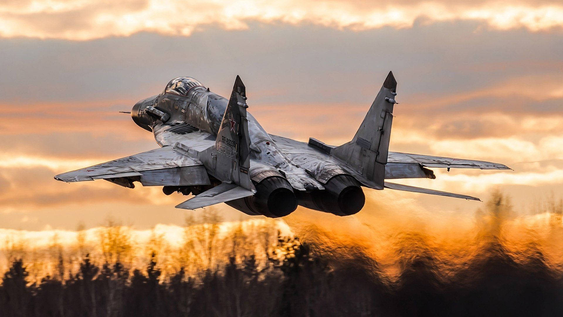 Caption: Majestic Mikoyan Mig-35 Fighter Jets Soaring Over A Forest