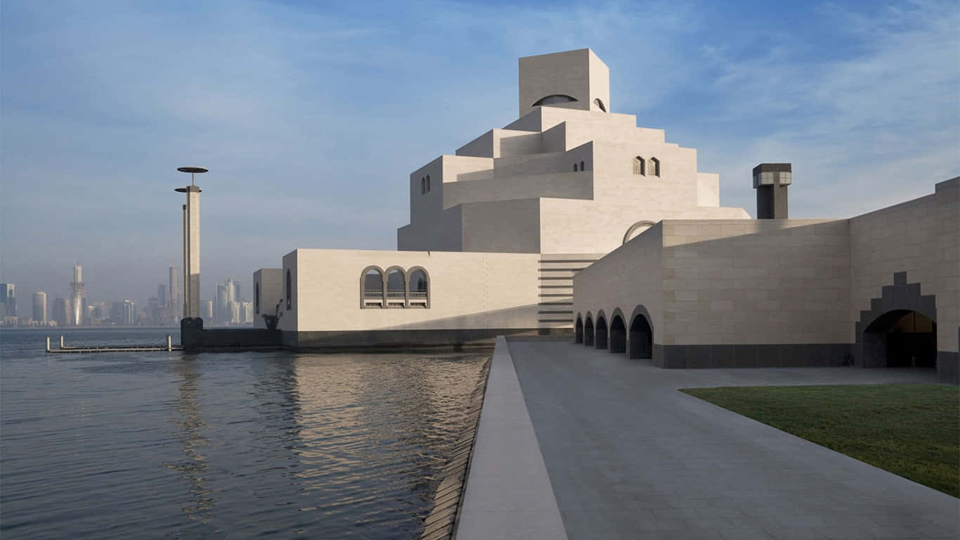 Caption: Majestic Museum Of Islamic Art Beneath A Clear Blue Sky Background