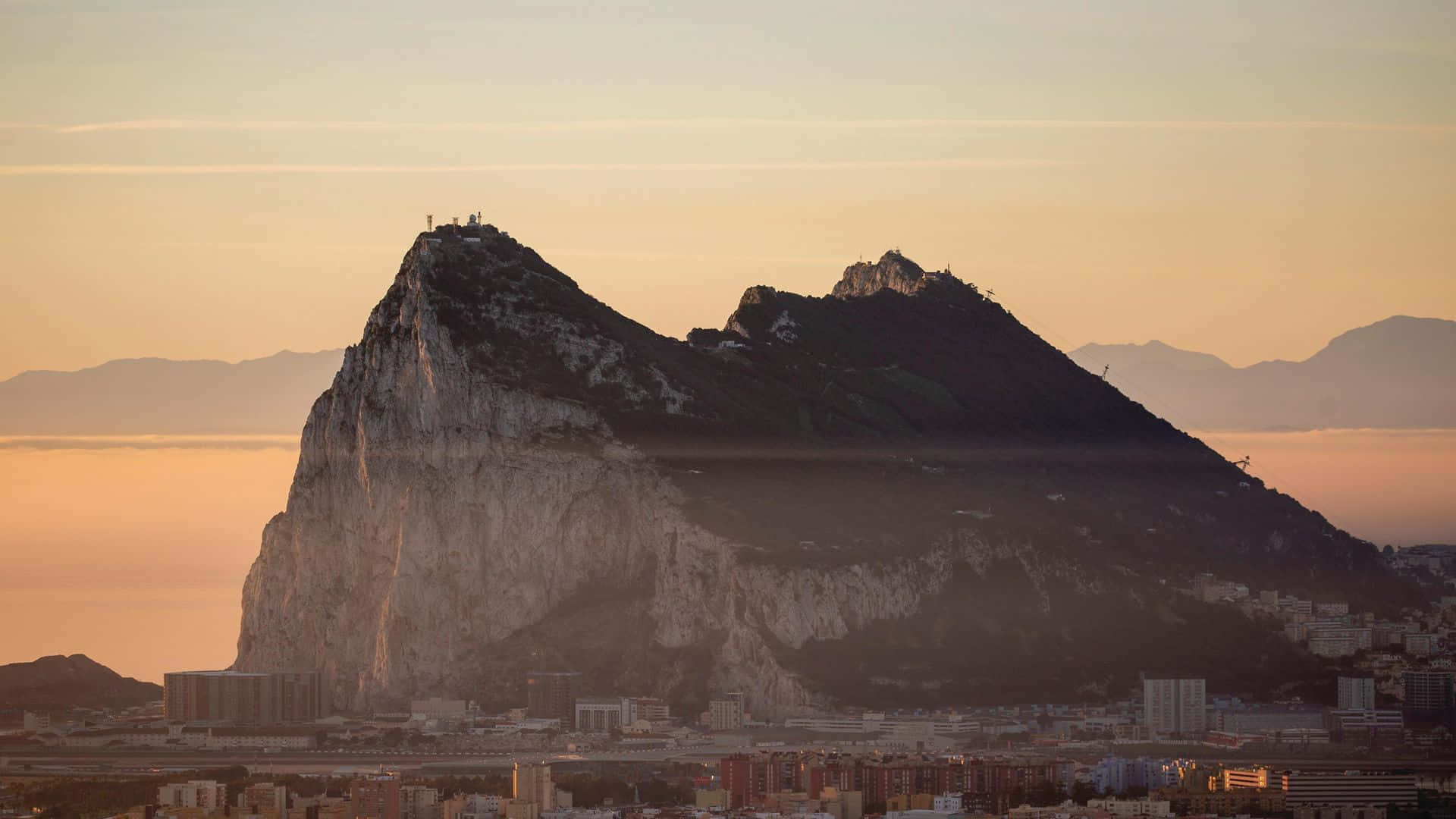 Caption: Majestic Sunset Over Rock Of Gibraltar Background