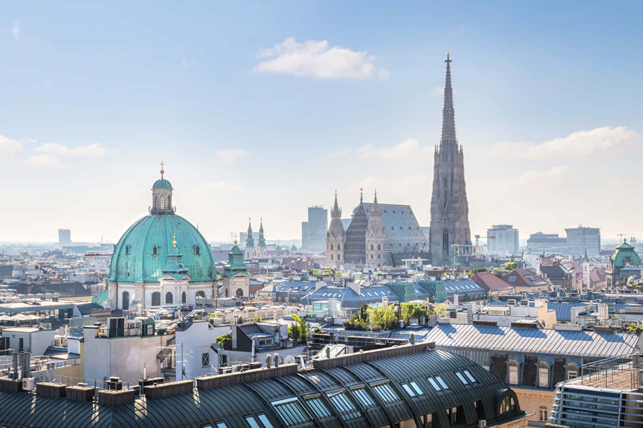 Caption: Majestic Vienna Cathedral At Sunset Background