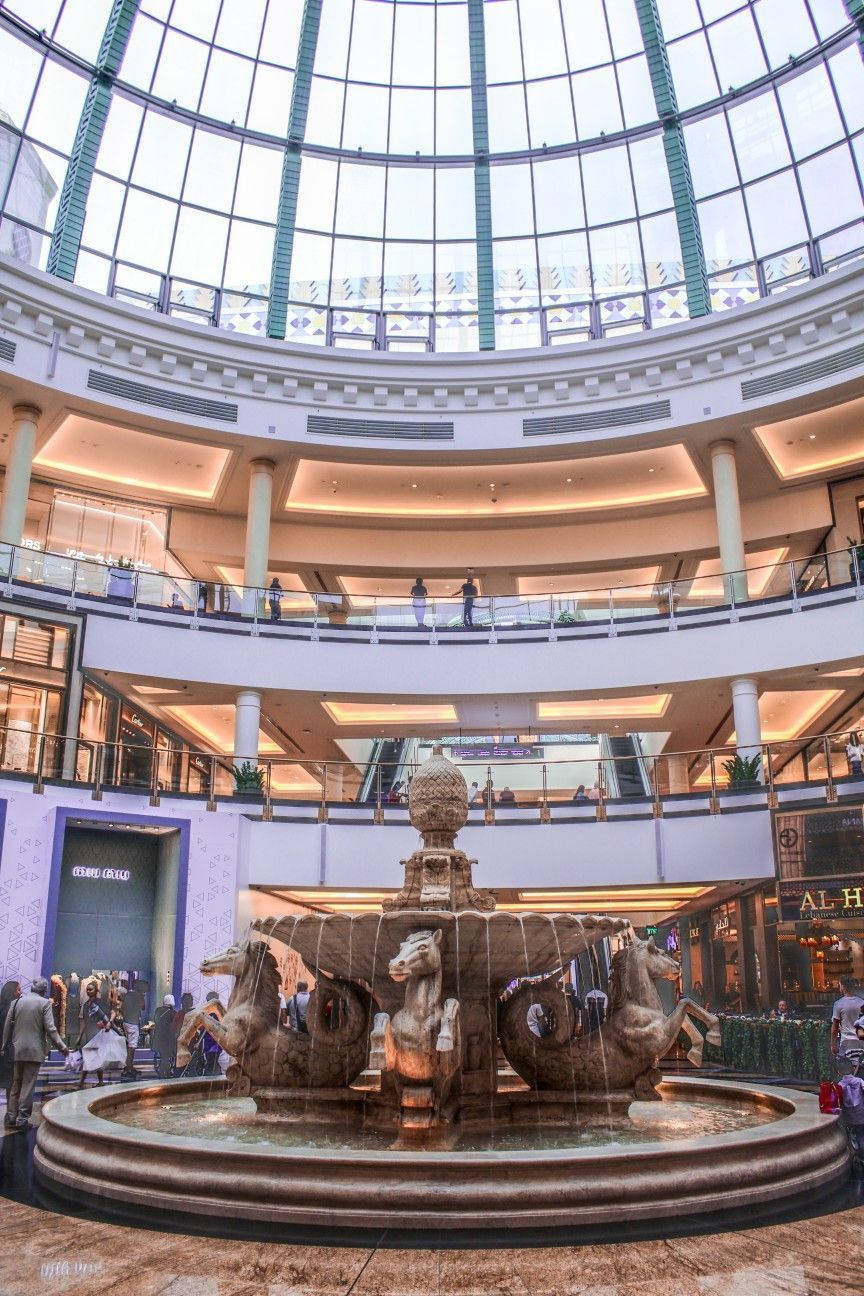 Caption: Majestic View Of Mall Of Emirates Indoor Fountain Background