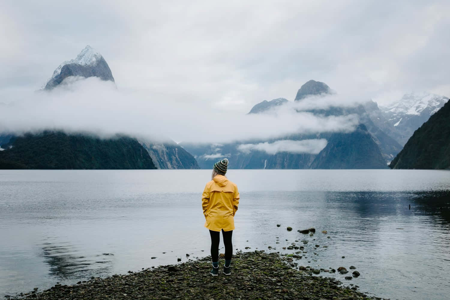 Caption: Majestic View Of Milford Sound And Its Rocky Landscape Background
